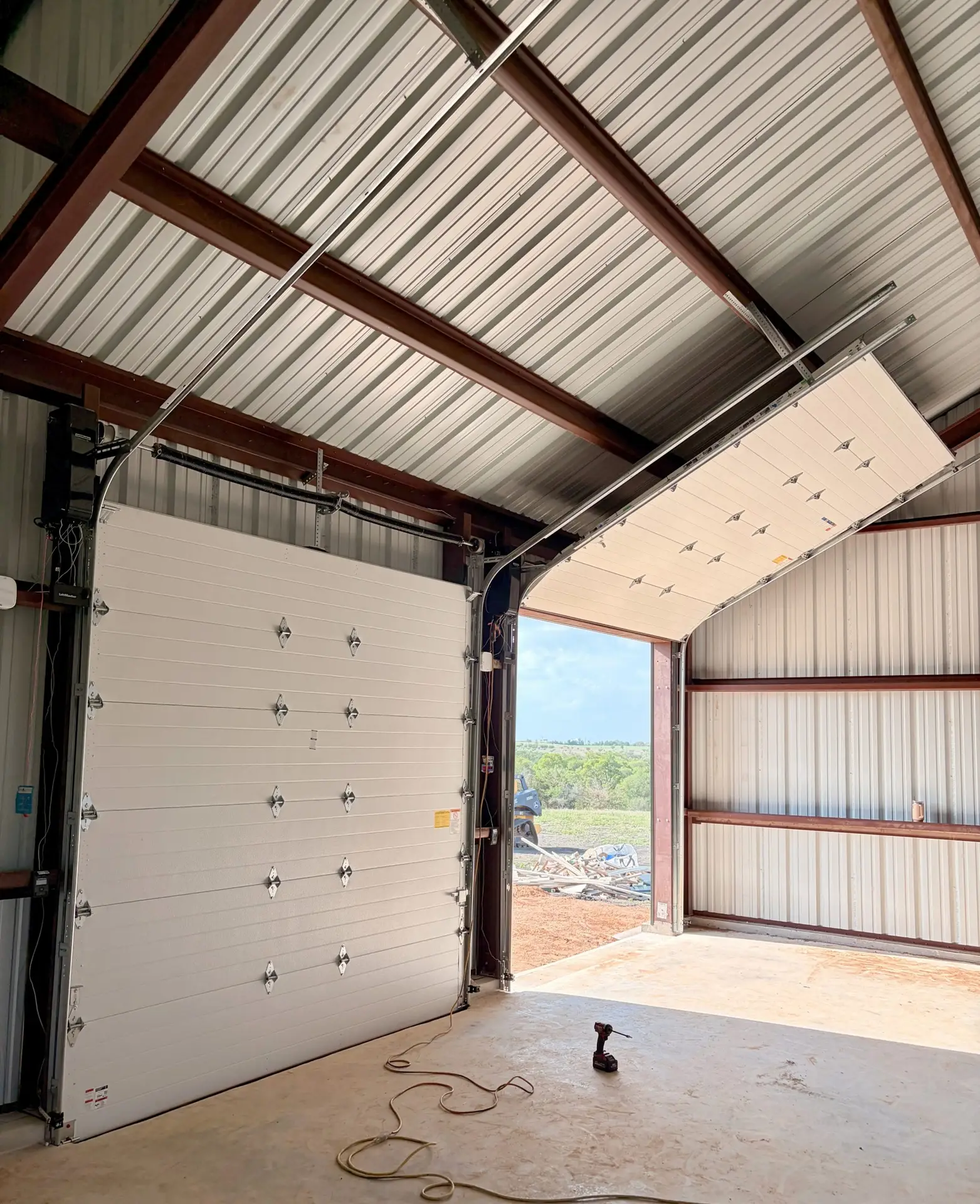 Commercial garage door tracks following roof pitch
